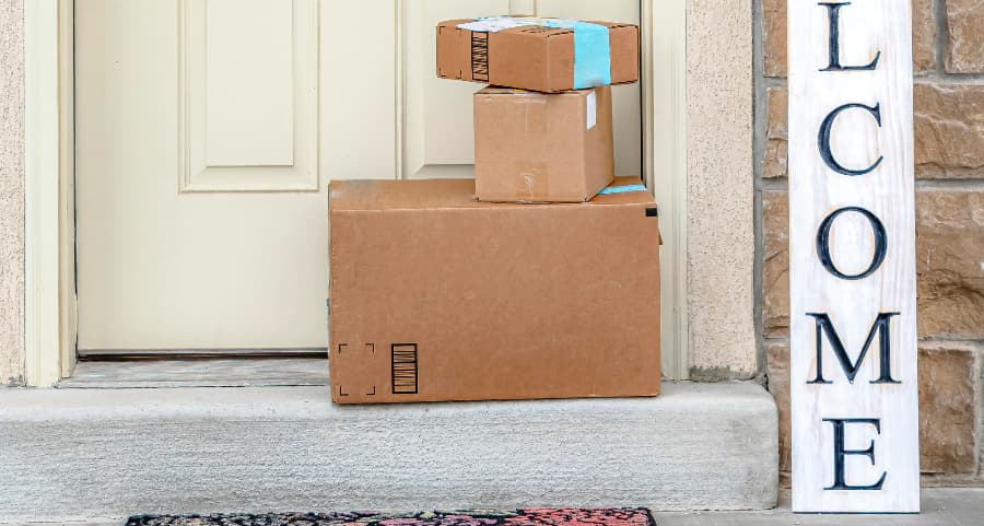 Packages on the doorstep of a home with a welcome sign in Phoenix